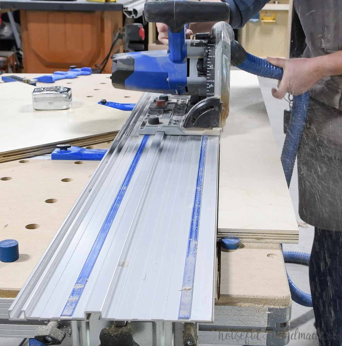 Cutting pegboard grooves into plywood with a plunge saw.