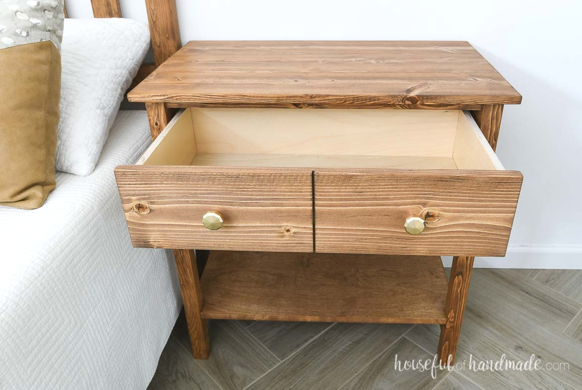 Large drawer on the top of the nightstand open with a drawer front made to look like 2 drawers.