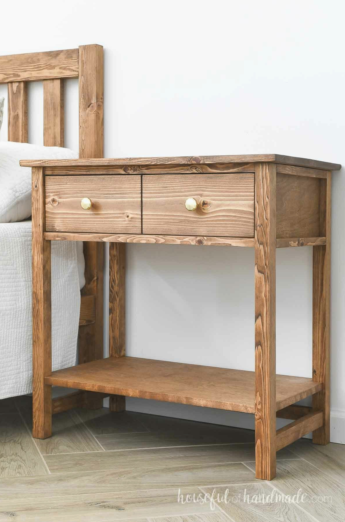 Wood nightstand with a drawer on top that looks like 2 drawers and an open shelf.