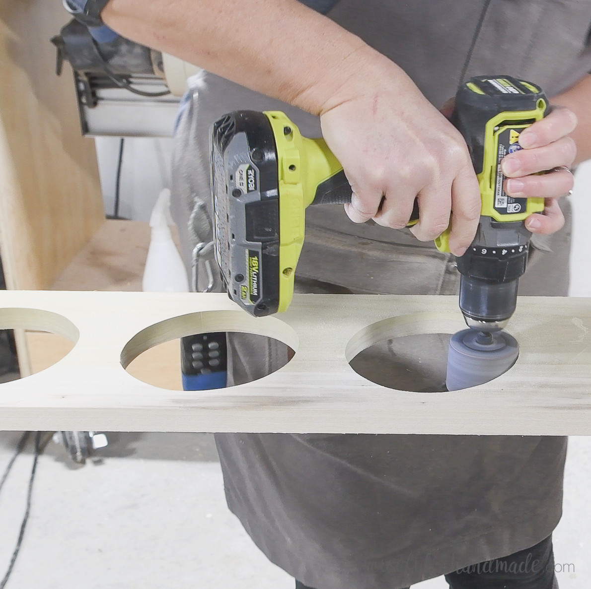 Sanding the inside of the holes with a drill sanding attachment.