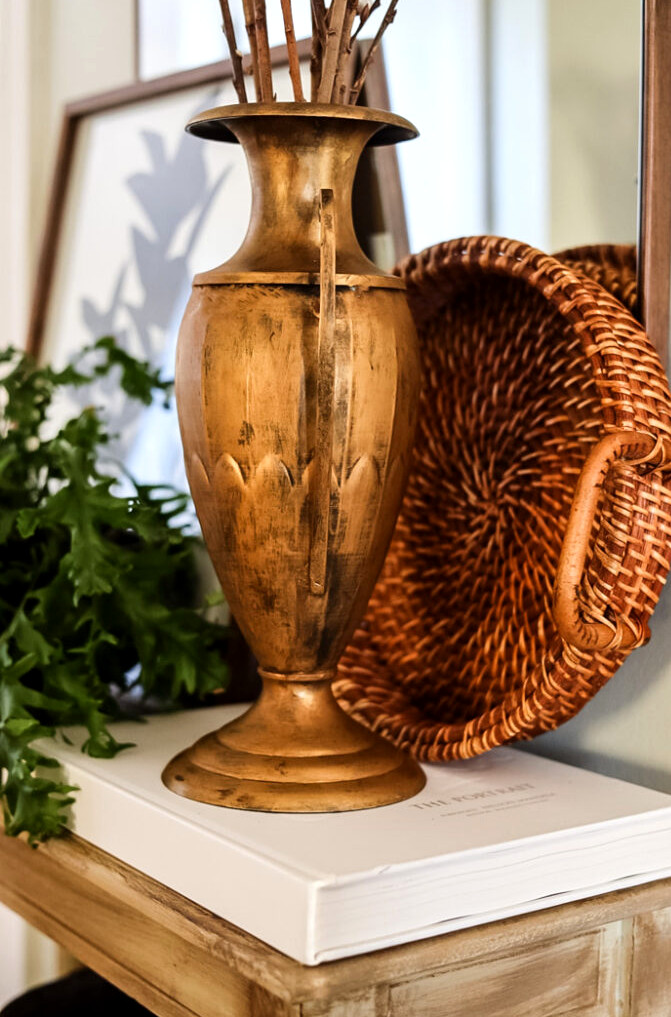 gold urn on an entryway table