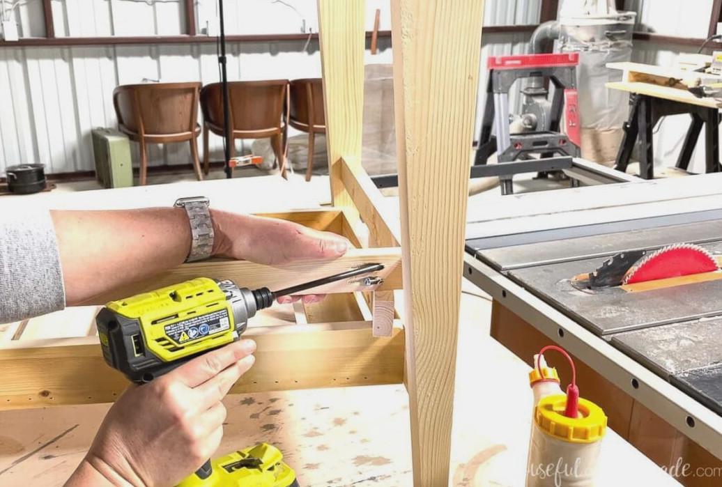 Securing the shelf rail to the back section of the vanity.
