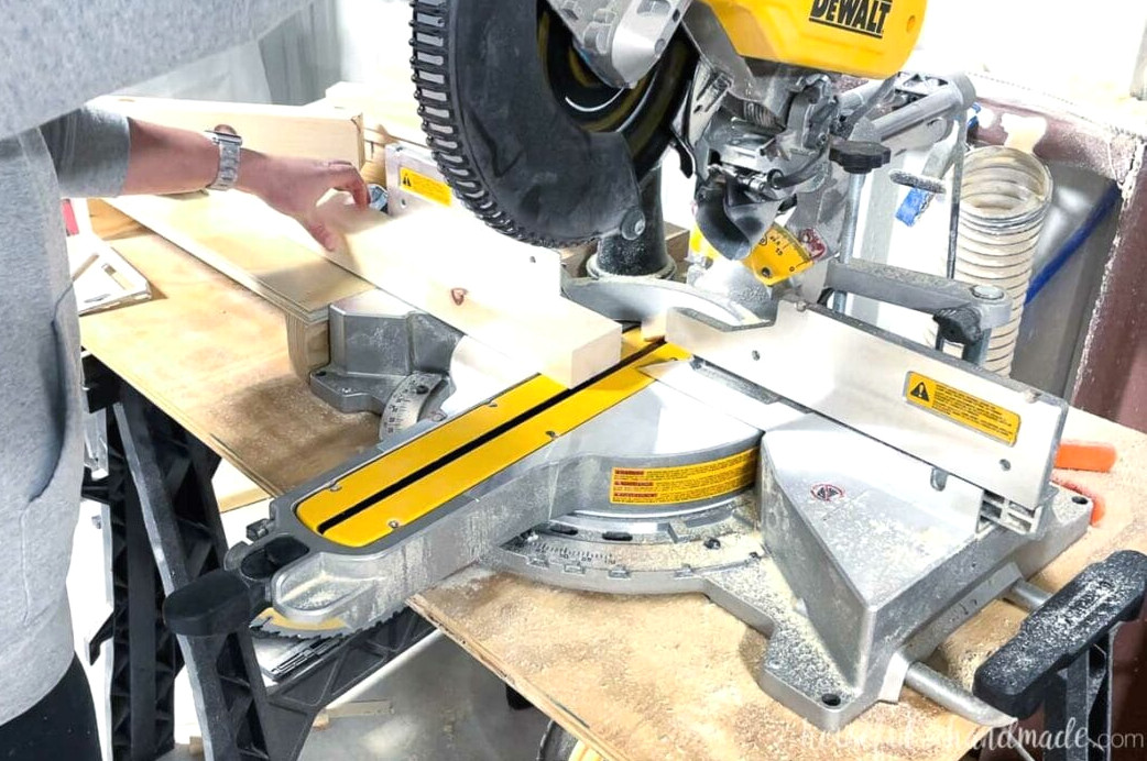 A 2x4 piece being cut at a 5 degree angle on a miter saw.