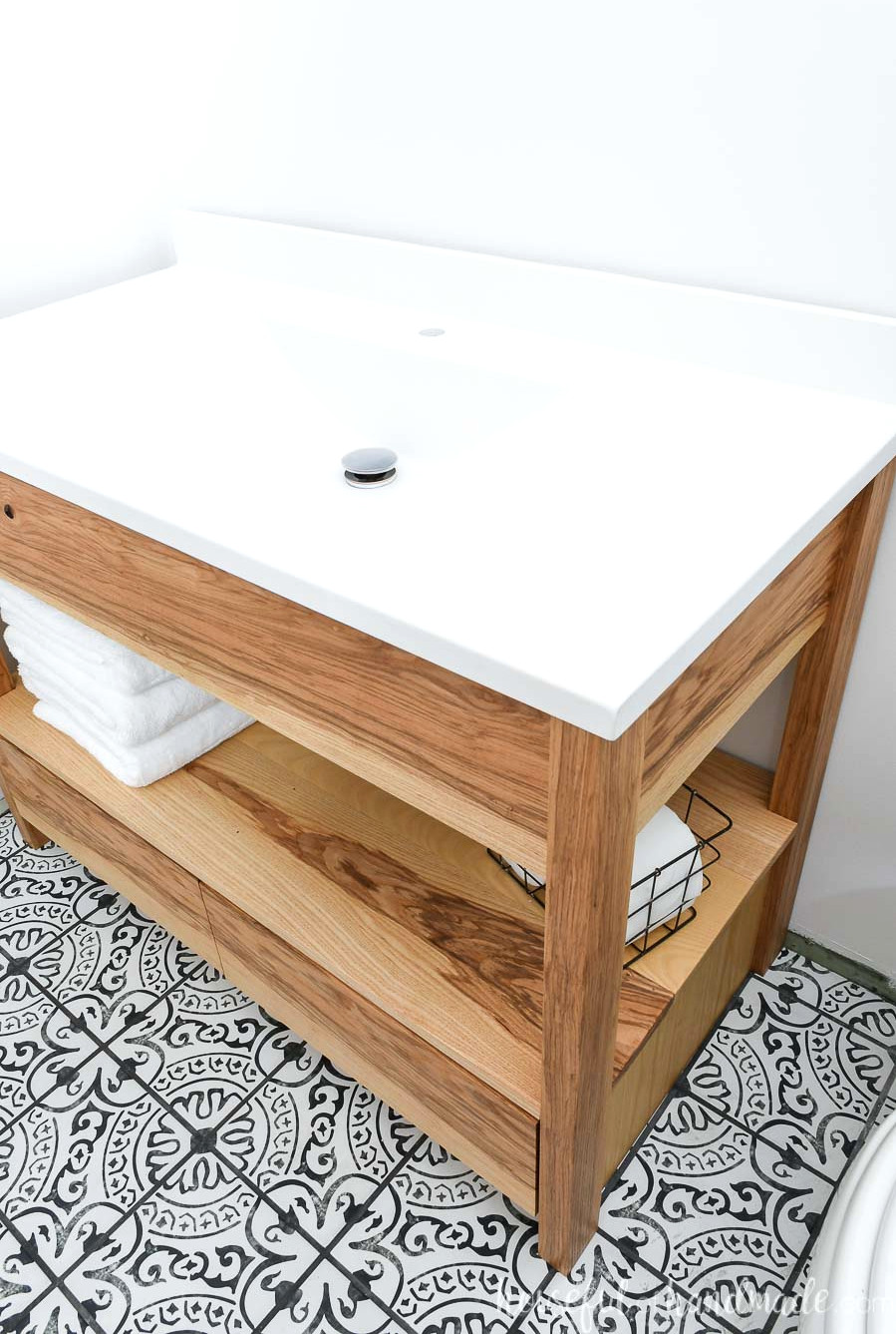 White single-piece vanity top with a sink installed on a 42" bathroom vanity made from these free plans. 