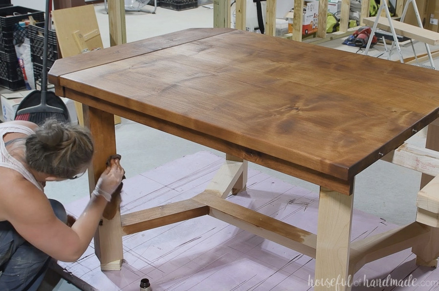 Buffing in the TrueTone color infused tung oil onto the legs of the dining table.