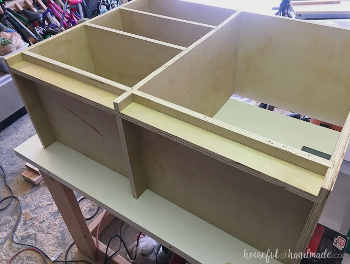 The bottom of the closet cabinet showing the toe kick installed in the grooves.