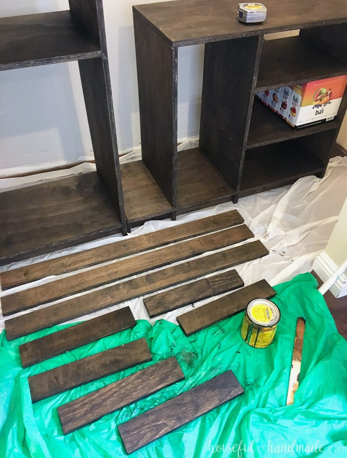 Showing the pieces cut for the closet shelf supports being stained to match the closet organizers.