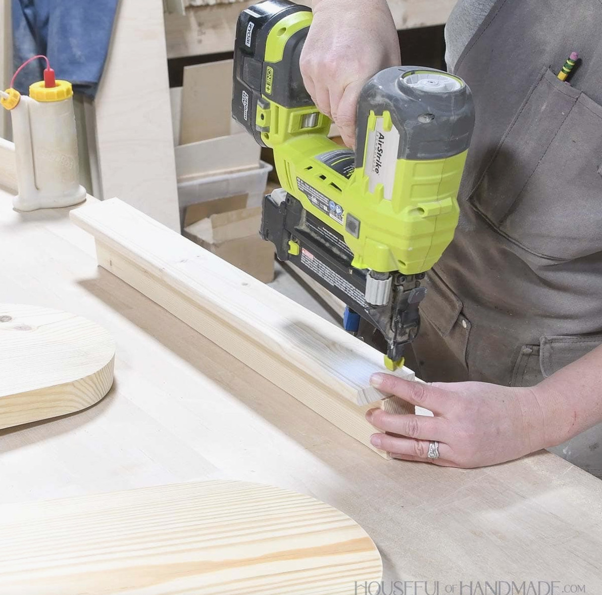 Securing a front board to the shelf with nails.