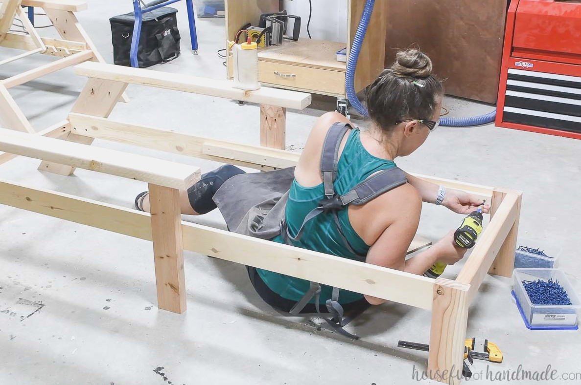 Adding a 1x2 board to the rails to support the seat slats.