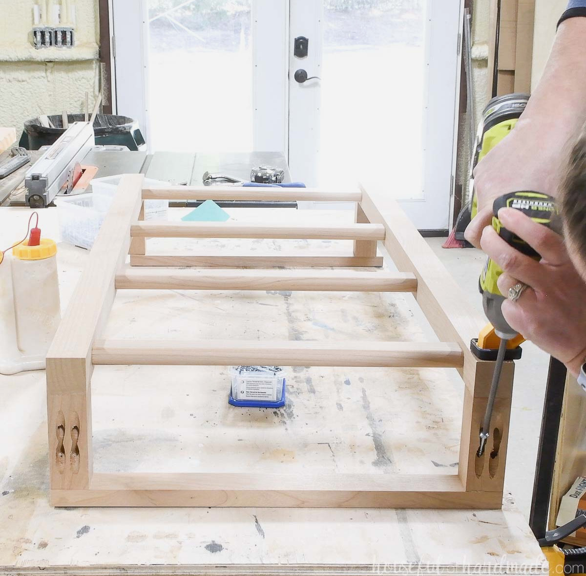 Fastening the back slat to the wall ladder with pocket hole screws.