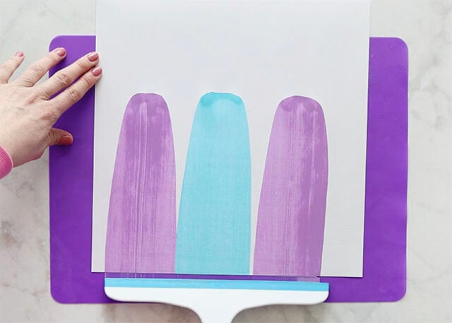 Drawing the squeegee downward