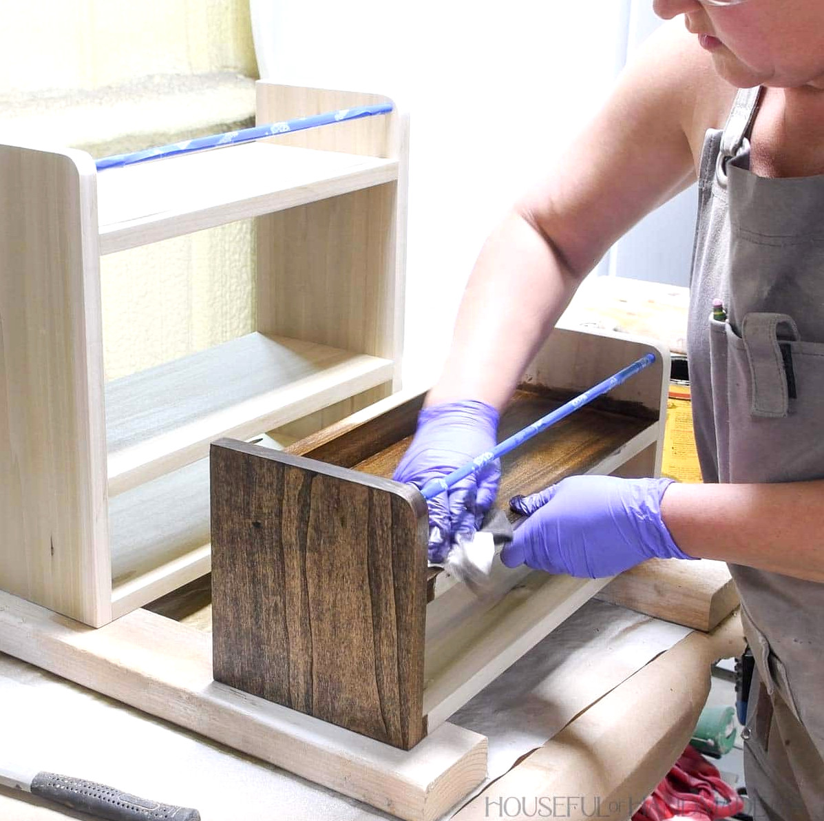 Staining the poplar shelves with a dark walnut color.