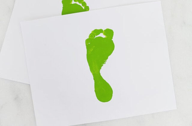 Green footprint on cardstock