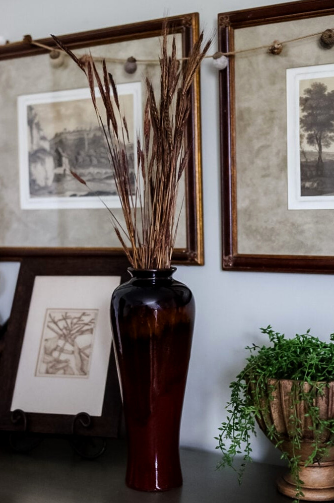tall vase with dried wheat in it