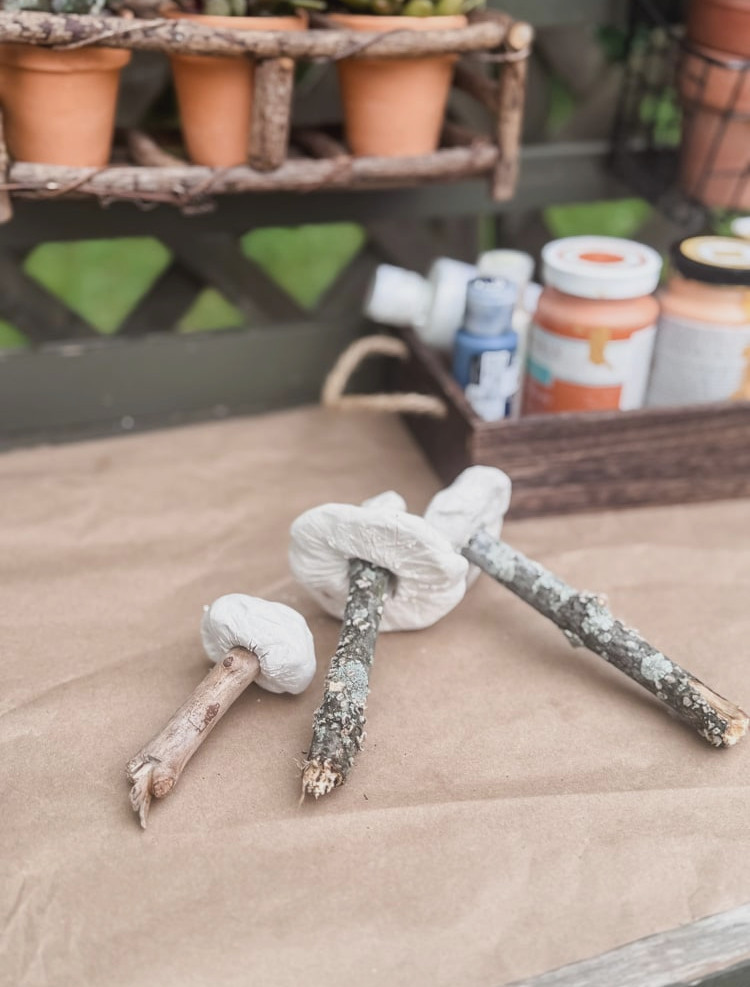 clay mushrooms resting on brown paper