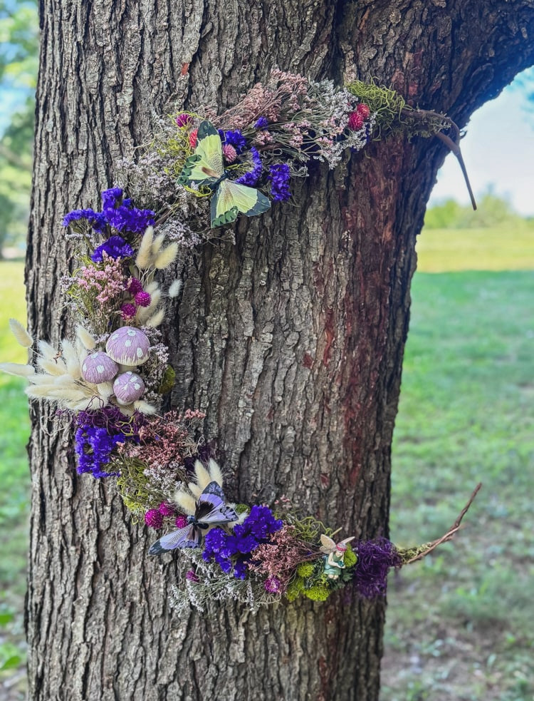 fairy wreath made with dried flowers hanging on a tree