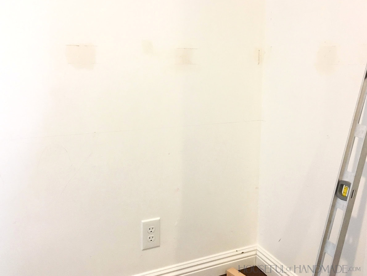 Unpainted empty closet interior with patched walls.
