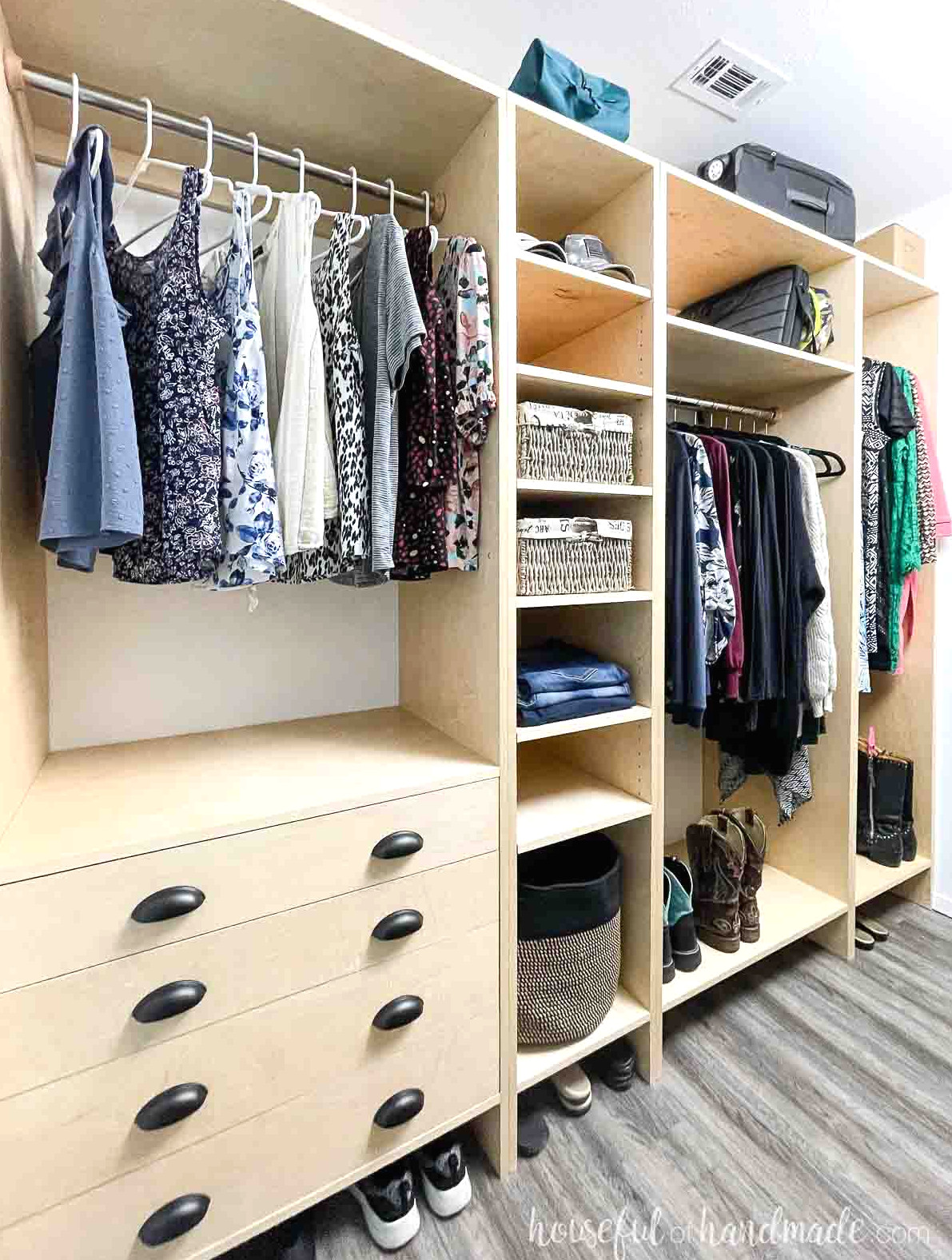 An 8' long DIY closet made from plywood, featuring drawers, numerous shelves, and ample hanging space.