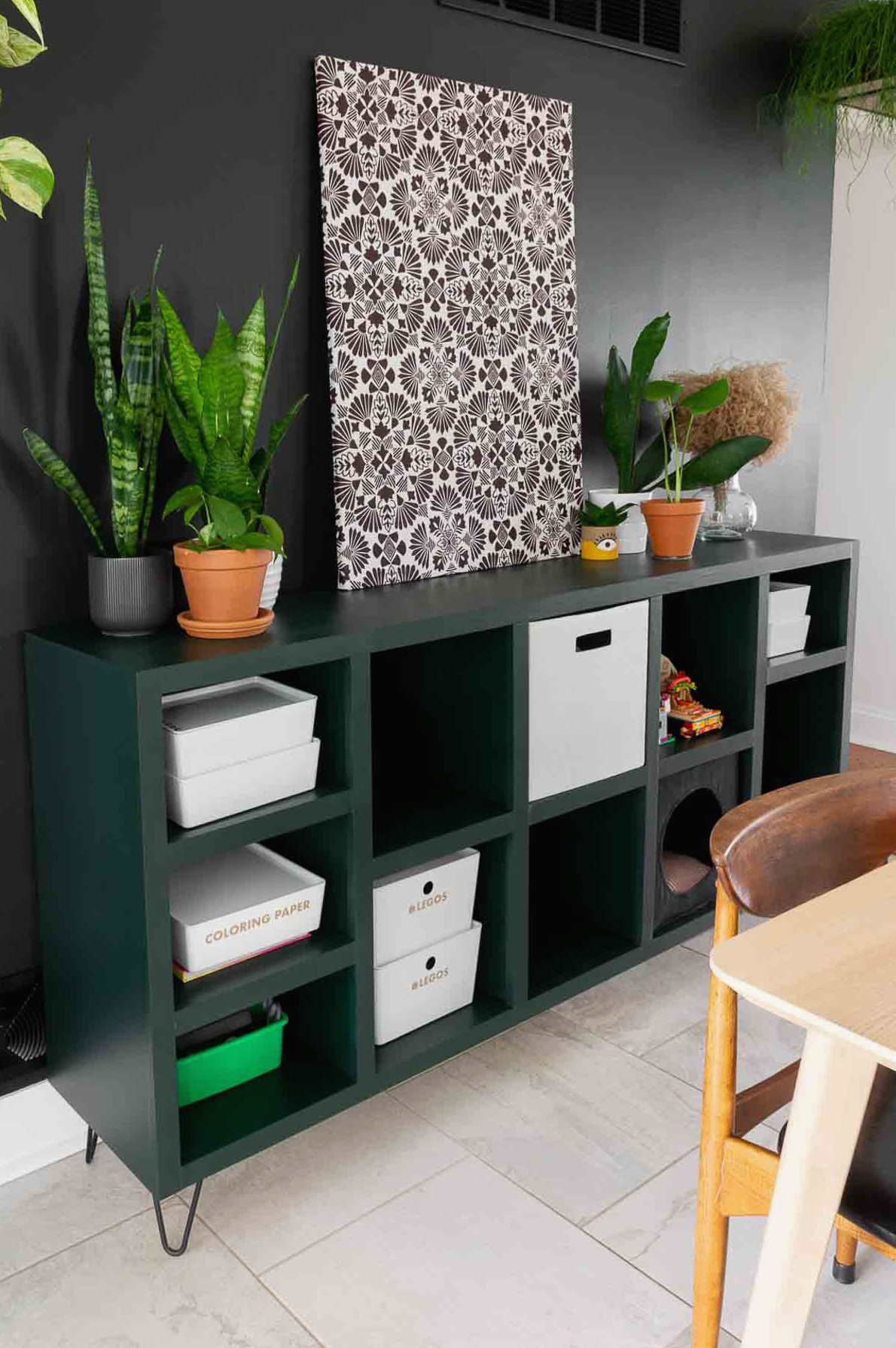 Cube storage compartments in a DIY console table finished with modern, moody paint.
