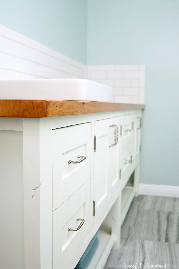 White mission style bathroom vanity with DIY wood vanity top.