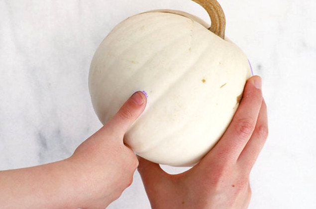 Stamping pastel dots onto pumpkin