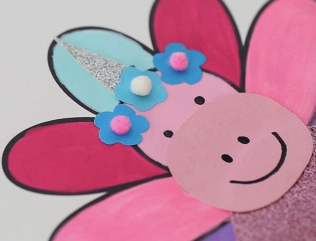 Glue on pom poms to flowers