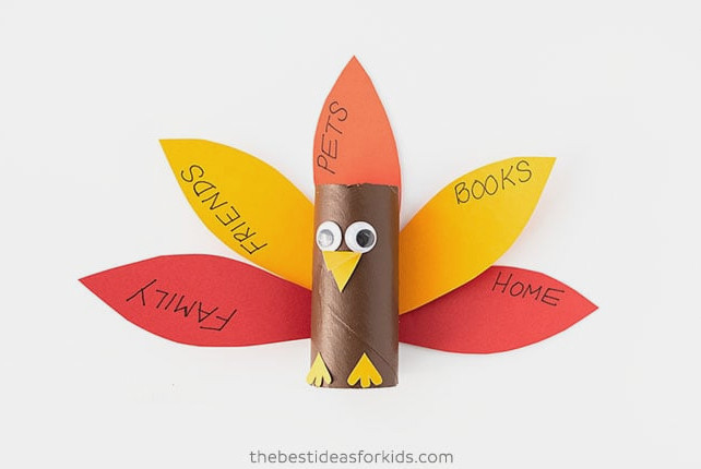 Glue the feathers to the paper roll