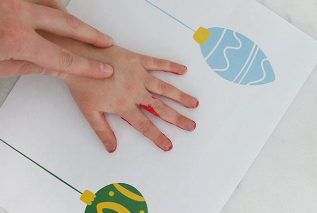 Pressing hand onto ornament sheet
