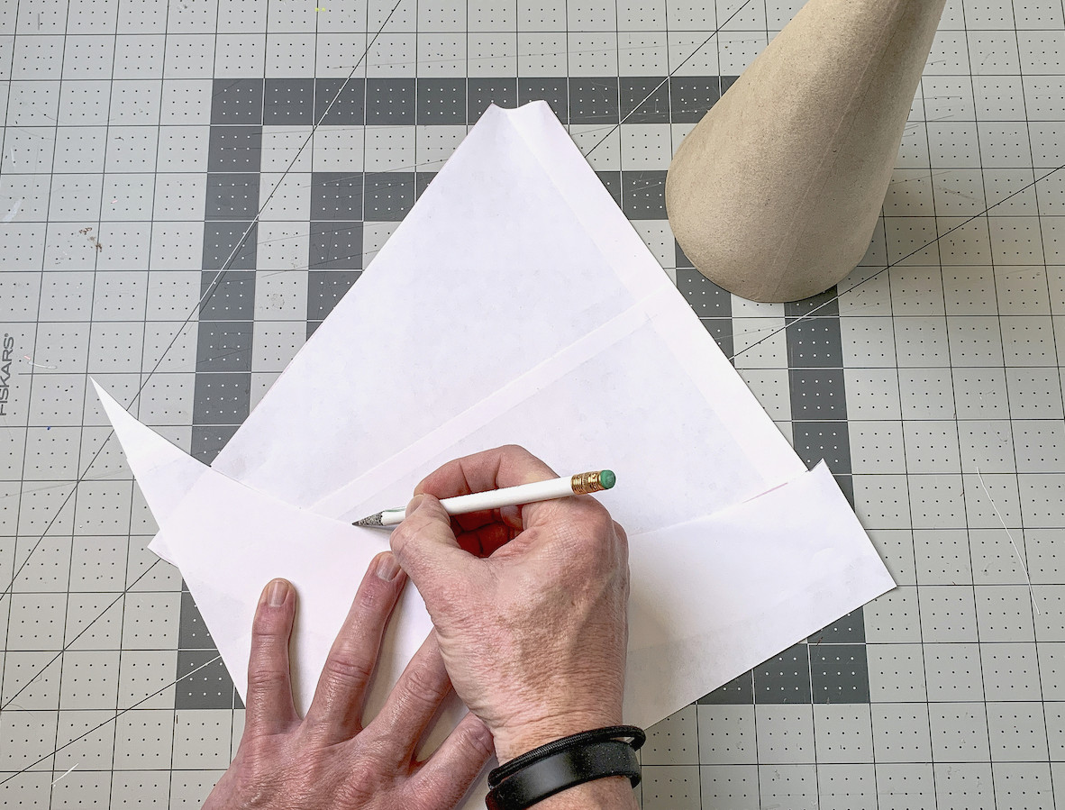 Trimming the base of the template using the excess paper