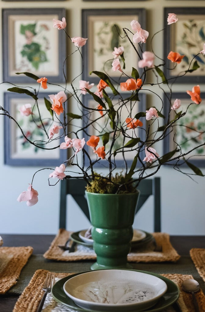 dining table with pretty green vase of paper cherry blossoms