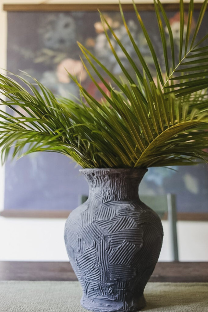 vase filled with tall palms