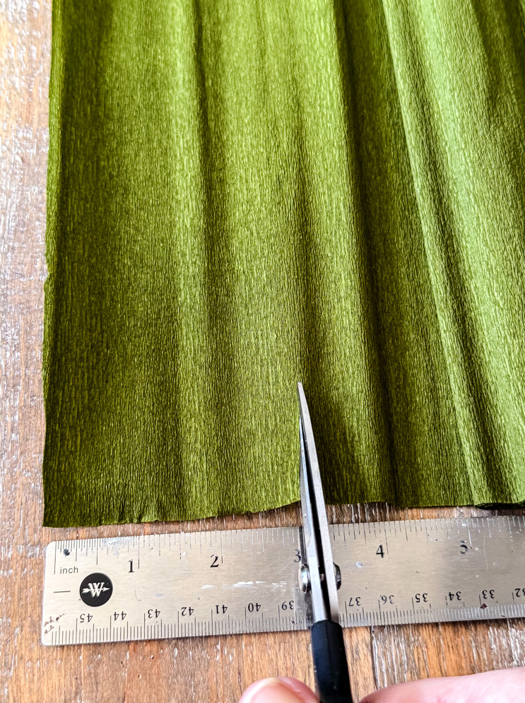 cutting green crepe paper