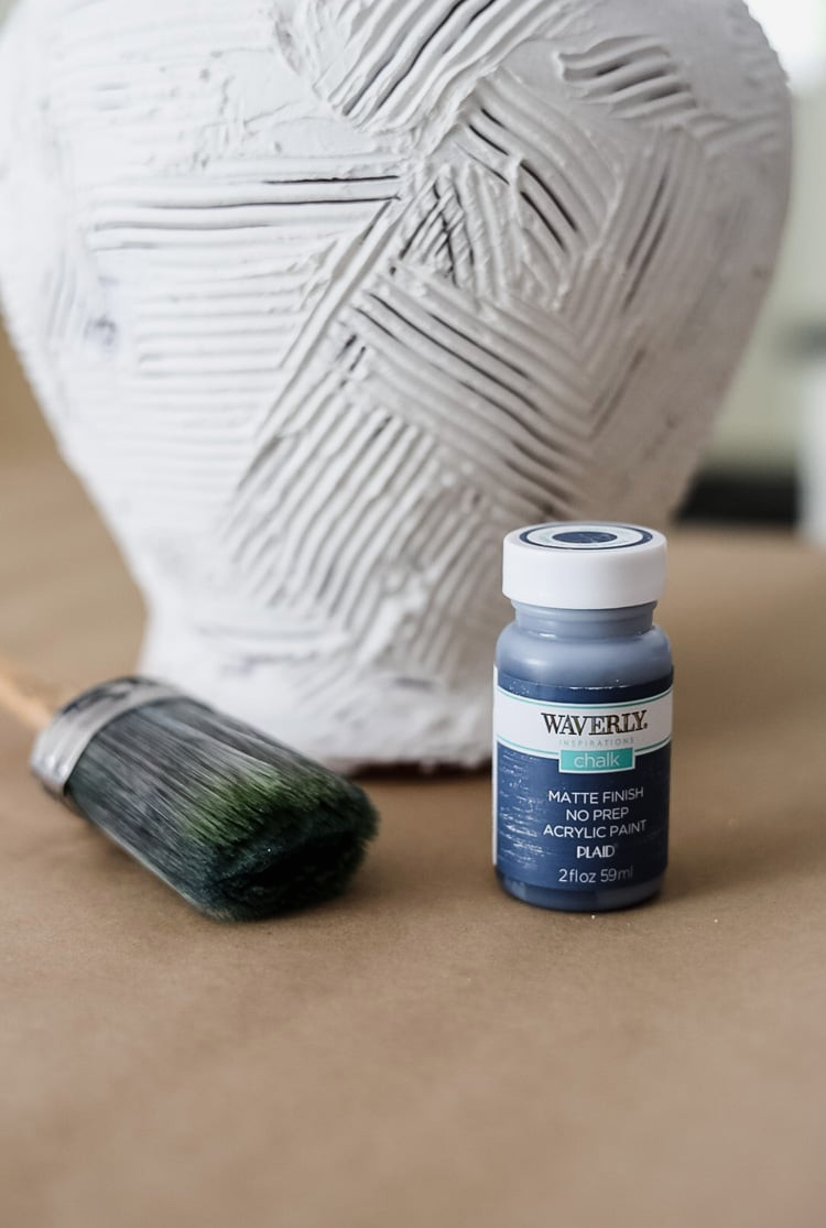 blue paint and big paintbrush