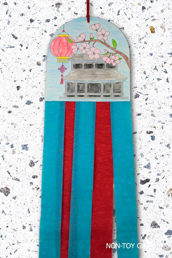 Printable Chinese New Year craft for kids showing a colorful hanging decoration with a traditional pagoda and red lantern design.