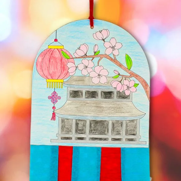 Kids Chinese New Year decoration craft with a pagoda illustration, cherry blossom branch, and long paper streamers for classroom or home display.