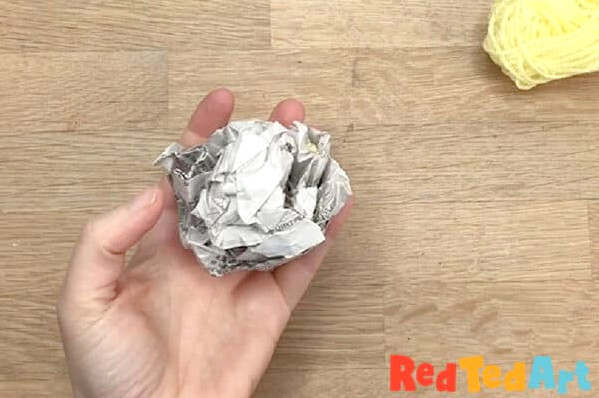 create a firm newspaper ball
