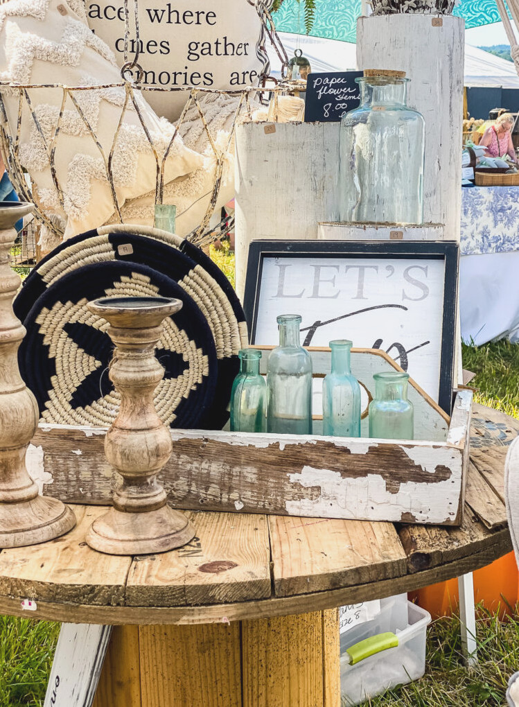 Vintage Glass Bottles and candlesticks on table