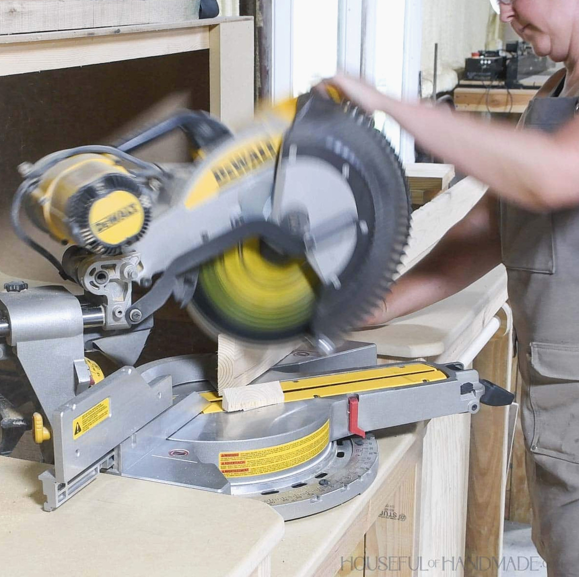 Ripping the edge of a 1x4 board at a 45 degree angle with a miter saw.
