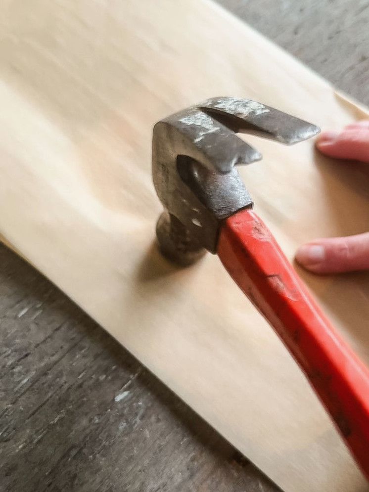 using the flower pounding method to make a card. here is a hammer and a piece of brown parchment paper