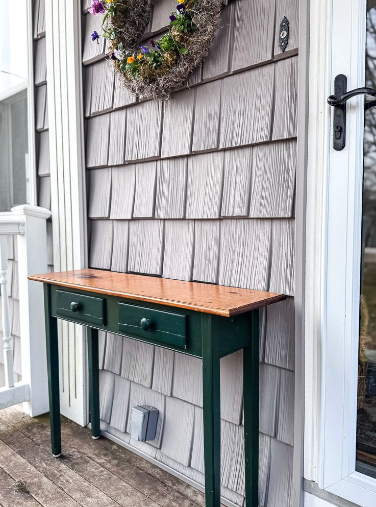 green console table on porch