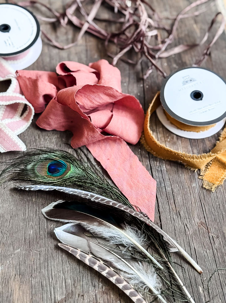 pile of rolls of ribbon and feathers