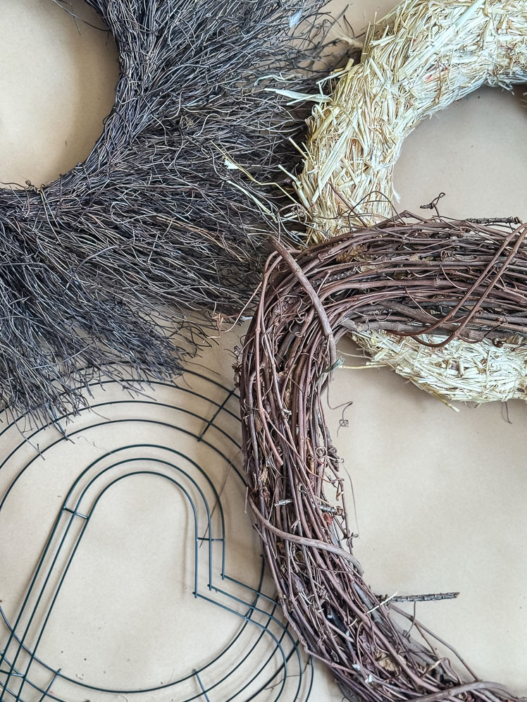 a flatlay of different types of wreath forms including wire, grapevine, and straw