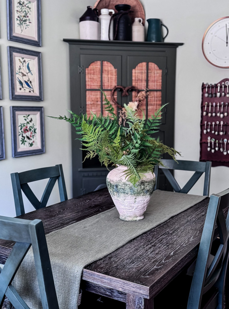 dining room table with vase of ferns