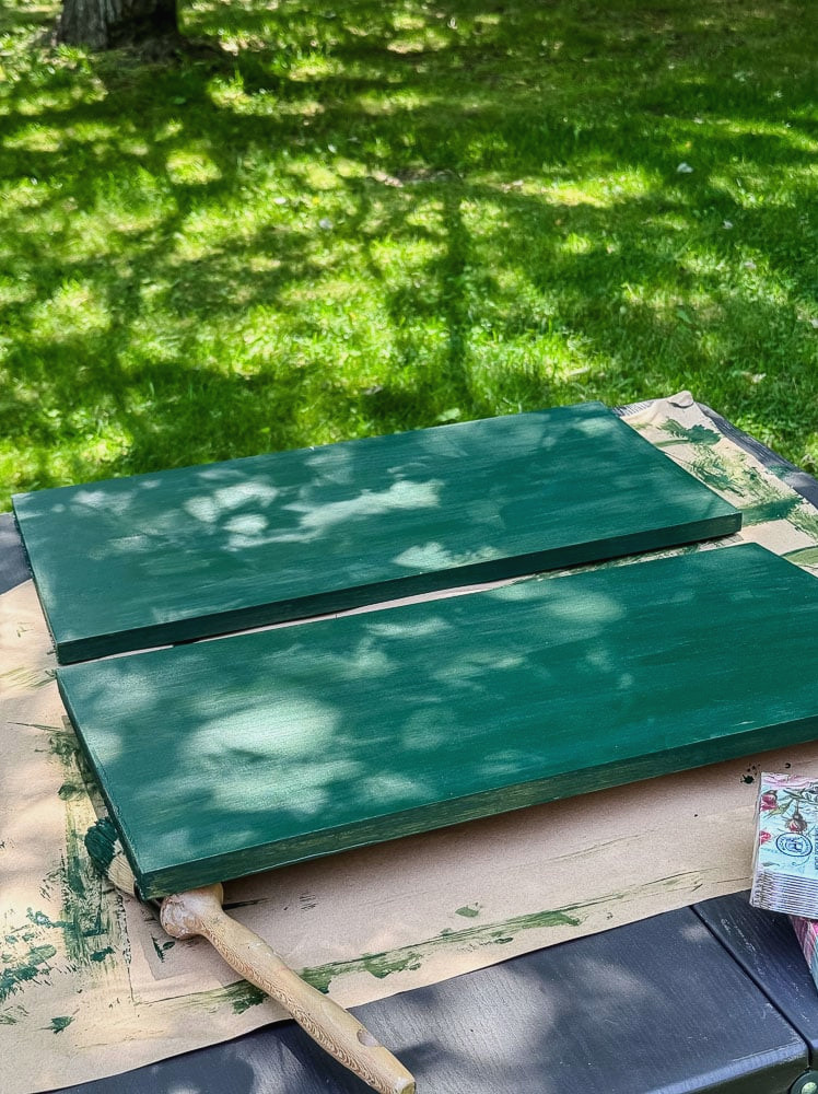 green wood boards on table that have just been painted